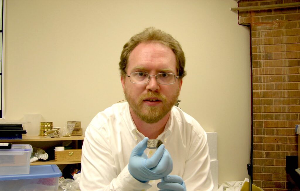 Br. Robert Macke with a moonrock from the Moon