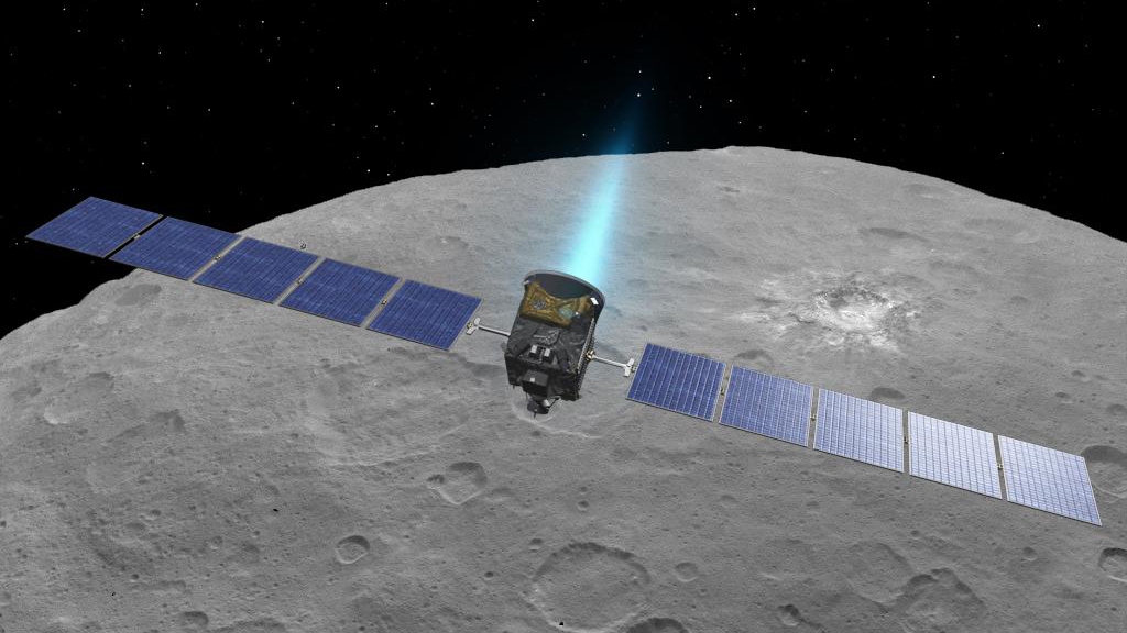 Artist concept of the Dawn spacecraft firing its ion engines above dwarf planet Ceres