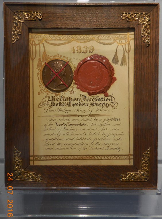 Plaque at Saint Mary-of-the-Woods which reads, ‘1839: Medallion Decoration conferred on Mother Theodore Guerin by Louis Philippe, King of France. Her schools were visited by a prefecteur of the “Forty Immortals,” her system and method of teaching examined, her own masterly attainments tested by profound questions and intricate problems. She stood the examination to the surprise and admiration of the “Learned Faculty.”’