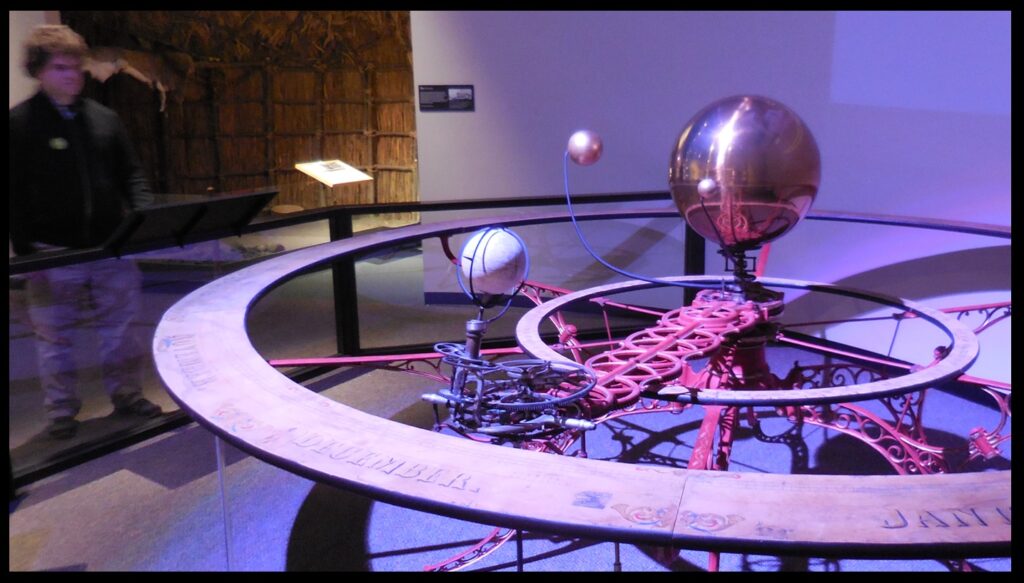 This image gives a sense of the size of the orrery.  The sun is the size of a large beach ball.  No doubt this large machine was a fantastic tool for explaining how the solar system functioned and why the seasons occur—much better than computer apps that do the same thing today, but that are confined to a 2-D screen that is much smaller than this 3-D model.