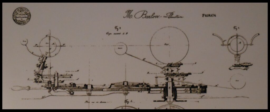 Part of a diagram of the orrery, showing a “side view” of the gear train that makes the orrery work.  At the end of the arm that holds the Earth and moon was a handle.  This handle was used to pull the Earth-moon system around the large wooden ring that comprises the circumference of the orrery.  The pulling action set a gear train in motion.  That gear train rotated the Earth, drove the moon to orbit the Earth, caused Earth’s axis to hold a constant angle (so that it would always point toward a “north star”), drove Mercury and Venus to orbit the sun, and caused the sun to rotate, all at the correct rates.  The machinery was sufficiently accurate that it could be used to predict or replicate alignments of the planets on given dates.