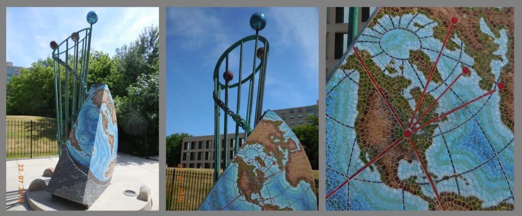 Sculpture near the corner of W. Prospect & E. Odgen streets.  Earth (with the location of Milwaukee highlighted) and planets are represented.  The sculpture is by Jill Sebastian and is titled “Eclipse.”