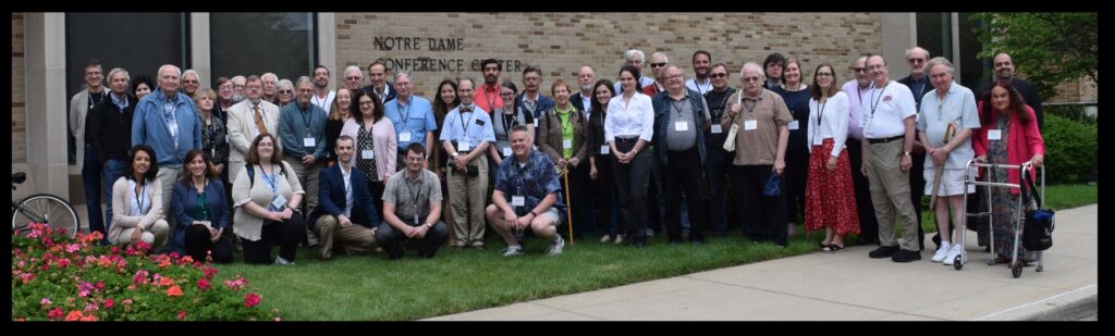 Attendees at the Fourteenth Biennial History of Astronomy Workshop at the University of Notre Dame.  Front row (crouched): Lois Rosson, Liz Hamm, Sarah Reynolds, Scott Trigg, Joseph Baxley, Matt Dowd.  Second row: Stephan Zieme, Mike Crowe, Marion Dolan, Ken Rumstay, Ken Launie, Louise Devoy, Sara Schechner, Jim Lattis, Adam Apt, Erica Meszaros, Trudy Bell, Laine Corfield, Voula Saridakis, Andrew Oakes, Christophe Wall-Romana, David DeVorkin, Beth Kessler, Marc Rothenberg, Jim Powell, Virginia Trimble.  Back row: Chris Graney, Connemara Doran, Cliff Cunningham, Tom Hockey, Horace Smith, Phil Shoemaker, Stella Cottam, Todd Timberlake, Lee Minnerly, Ariel Cohen, Hannah Kaufman, Omar Nasim, Durruty Jesus de Alba Martínez, Yaakov Zik, Dana Freiburger, Jamie Brannon, Salvatore Buonocore, Allan Olley, Samantha Thompson, Irv Berlin, Robert Smith, Pedro Raposo.