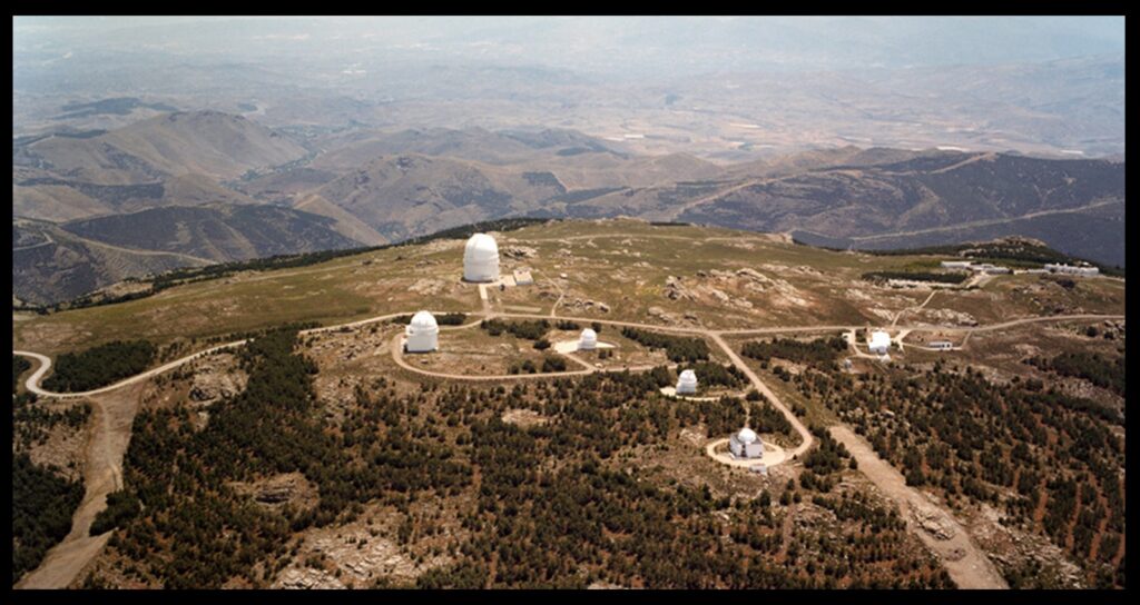 An aerial view of Calar Alto observatory, located at 2,100 meters altitude, in the province of Almería in Andalucía, Southern Spain. The biggest dome hosts a 3.5 meter telescope, the largest optical telescope in continental Western Europe. The 2.2 meter telescope with which we did the work described here is inside the leftmost dome.