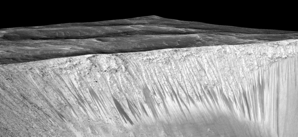 Dark narrow streaks, called 'recurring slope lineae,' emanate from the walls of Garni Crater on Mars. Credit: NASA/JPL-Caltech/Univ. of Arizona 