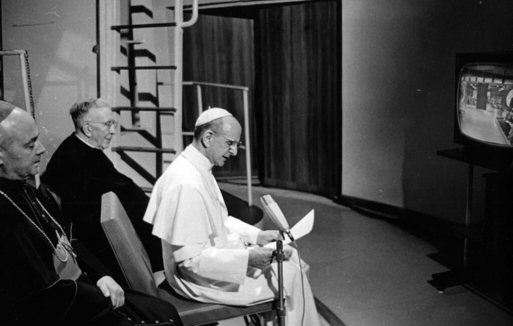 Pope St. Paul VI watching the Apollo 11 moon landing on TV and giving an address and blessing to the astronauts.