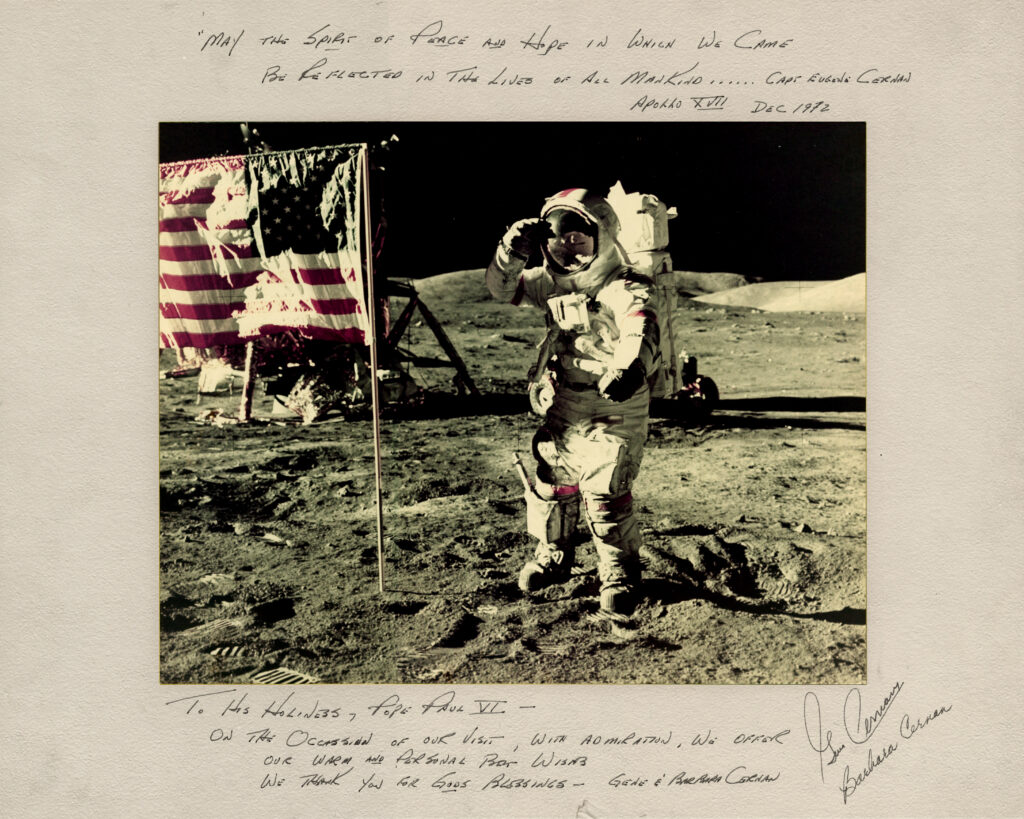 Astronaut on surface of moon, saluting American flag